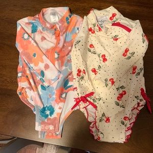 A pair of baby girl bathing suits, never worn